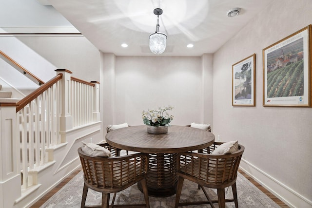 dining area with wood finished floors, stairway, baseboards, and recessed lighting