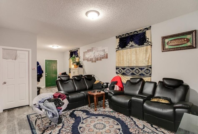 living room with a textured ceiling and light colored carpet