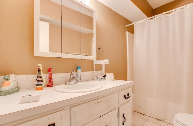 full bathroom featuring tile patterned flooring, vanity, toilet, and shower / bathtub combination with curtain