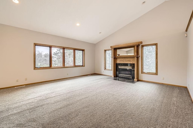 unfurnished living room featuring carpet, high vaulted ceiling, and a high end fireplace