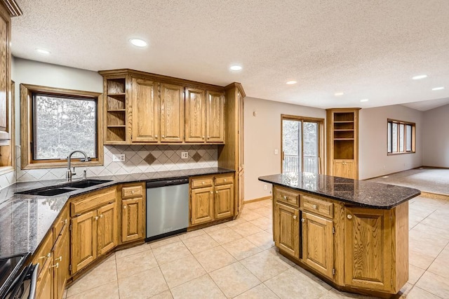 kitchen featuring sink, electric range oven, dark stone countertops, stainless steel dishwasher, and decorative backsplash