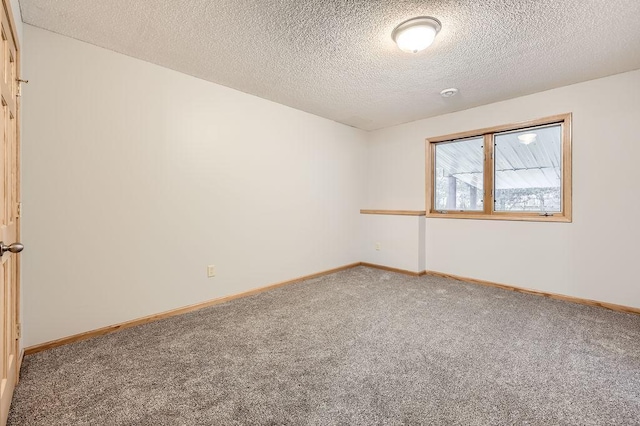 carpeted spare room with a textured ceiling