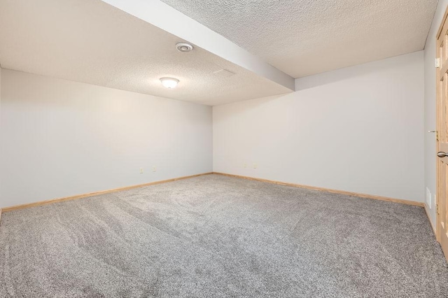 carpeted spare room featuring a textured ceiling