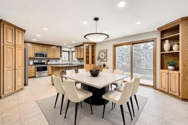 tiled dining area featuring a textured ceiling