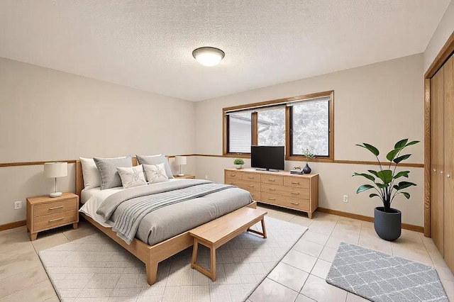 tiled bedroom with a textured ceiling