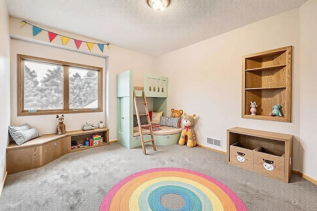 recreation room with carpet flooring and a textured ceiling