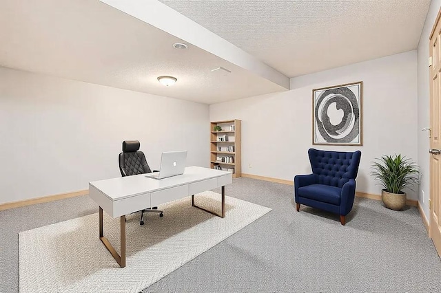 home office featuring carpet flooring and a textured ceiling