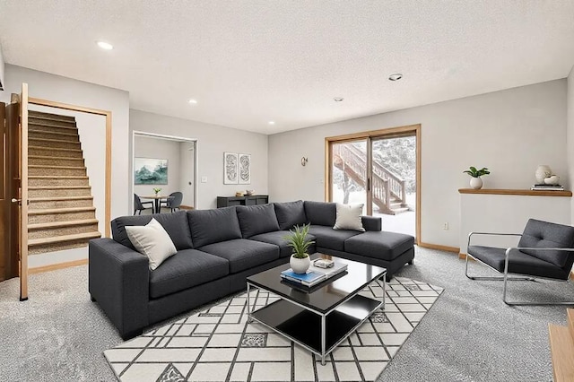 carpeted living room featuring a textured ceiling