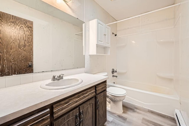 full bathroom featuring shower / bathing tub combination, wood-type flooring, vanity, baseboard heating, and toilet