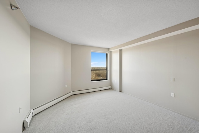 empty room featuring light colored carpet and a textured ceiling