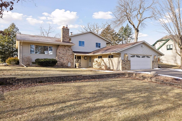 view of front of property featuring a garage and a front yard