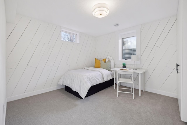 bedroom with light colored carpet and multiple windows