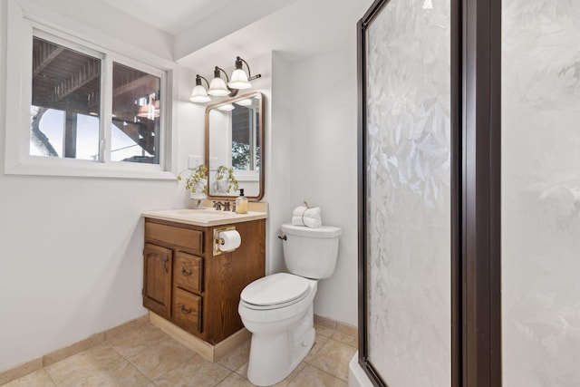 bathroom with vanity, tile patterned flooring, toilet, and walk in shower