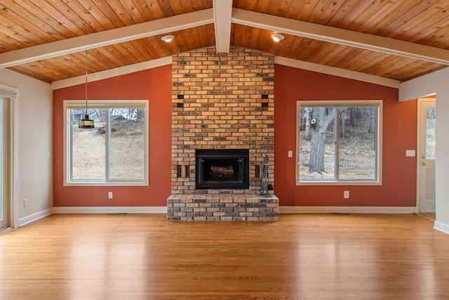 unfurnished living room with baseboards, wood ceiling, wood finished floors, vaulted ceiling with beams, and a fireplace