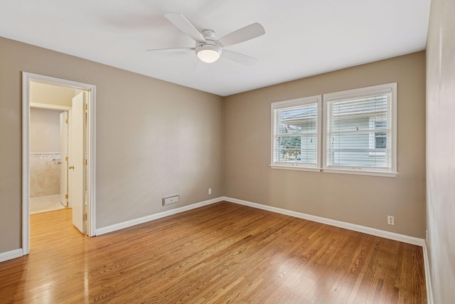 empty room with light wood-style floors, baseboards, and a ceiling fan