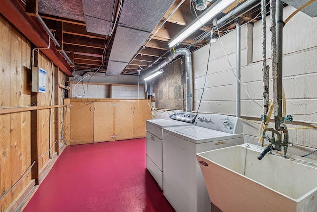 clothes washing area featuring laundry area, washer and dryer, and a sink