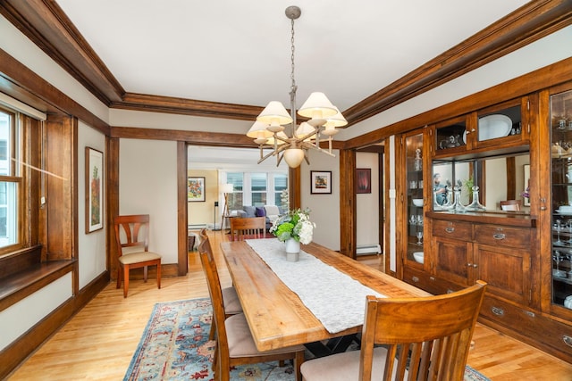 dining room with crown molding, light hardwood / wood-style flooring, a baseboard heating unit, and an inviting chandelier