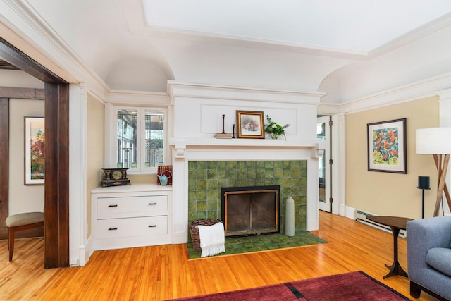 2328 3rd St, Duluth, MN 55812 - living room with light wood-style flooring, a tile fireplace, and ornamental molding