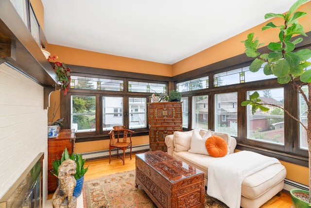 2328 3rd St, Duluth, MN 55812 - living room with a baseboard heating unit, wood finished floors, and a fireplace