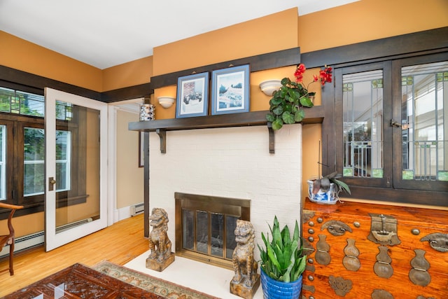 2328 3rd St, Duluth, MN 55812 - living area with plenty of natural light, wood finished floors, baseboard heating, and a brick fireplace