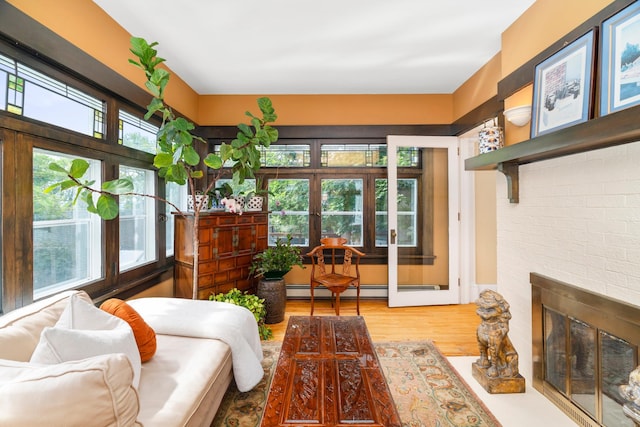 2328 3rd St, Duluth, MN 55812 - living room featuring wood finished floors, a fireplace, and a baseboard heating unit