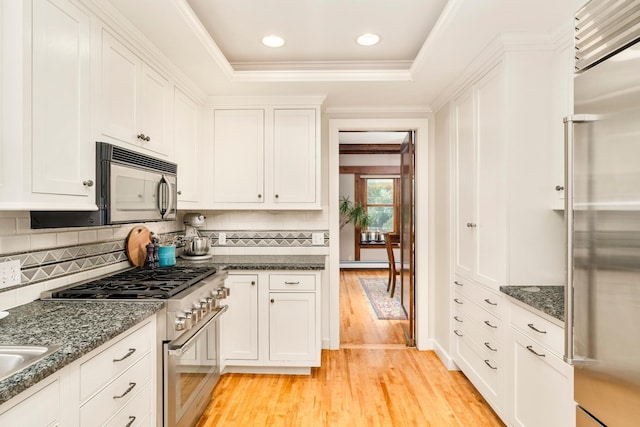 2328 3rd St, Duluth, MN 55812 - kitchen with high end appliances, light wood-style flooring, white cabinetry, tasteful backsplash, and recessed lighting