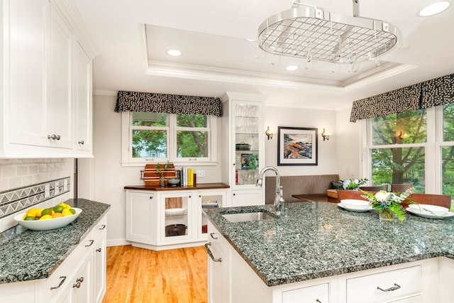 2328 3rd St, Duluth, MN 55812 - kitchen featuring ornamental molding, a tray ceiling, white cabinetry, and recessed lighting