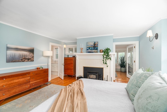 2328 3rd St, Duluth, MN 55812 - bedroom featuring ornamental molding, wood finished floors, a fireplace, and ensuite bathroom