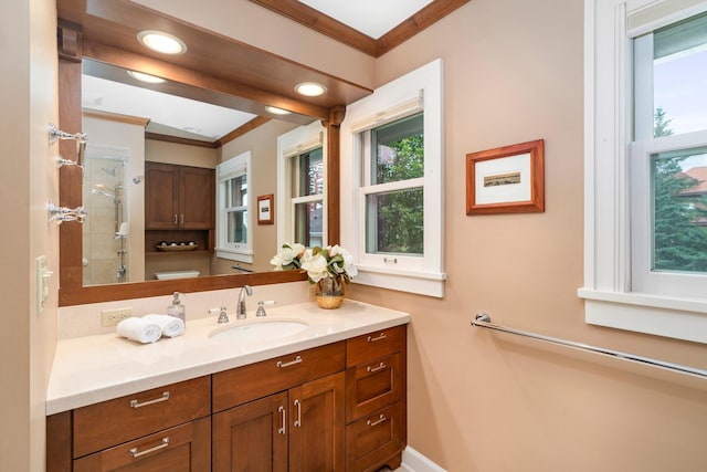 2328 3rd St, Duluth, MN 55812 - full bath with ornamental molding, vanity, a tile shower, healthy amount of natural light, and recessed lighting
