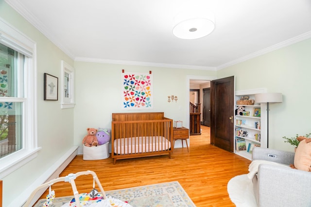 2328 3rd St, Duluth, MN 55812 - bedroom with wood finished floors, ornamental molding, and multiple windows