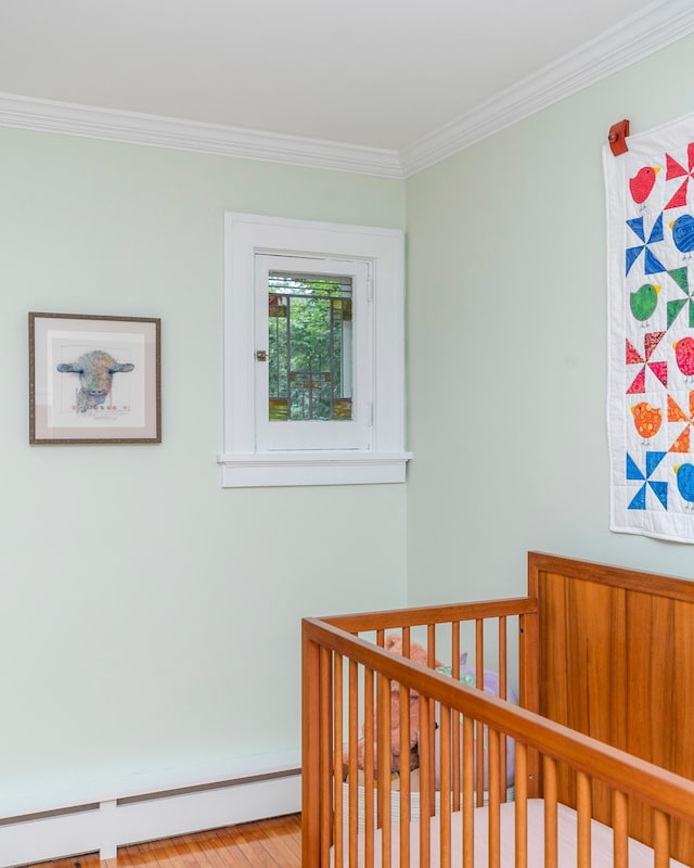 2328 3rd St, Duluth, MN 55812 - bedroom with a baseboard heating unit, ornamental molding, and a crib