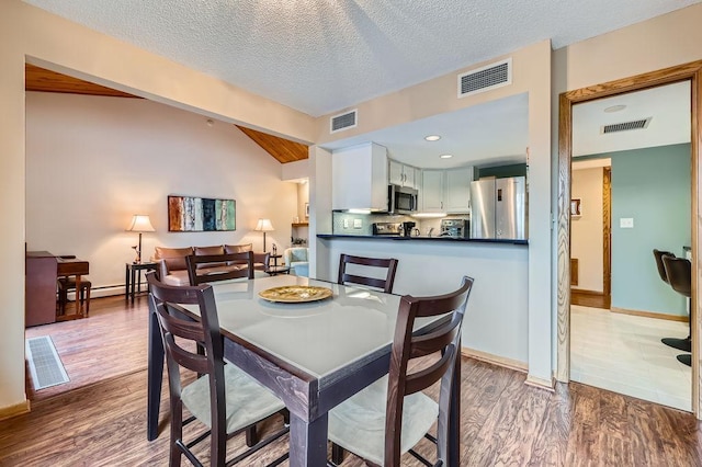 dining room with visible vents and wood finished floors