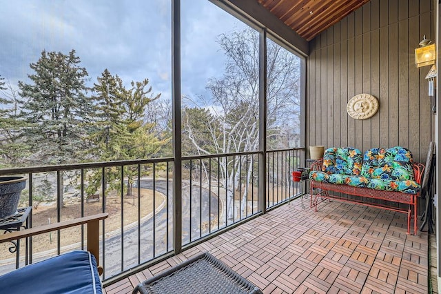 sunroom featuring lofted ceiling