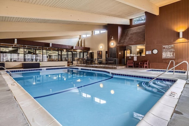 community pool with an indoor hot tub and a patio area