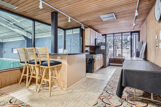 interior space with a baseboard heating unit and outdoor wet bar