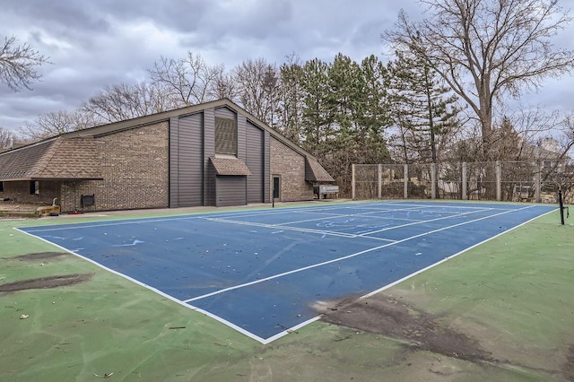 view of tennis court featuring fence