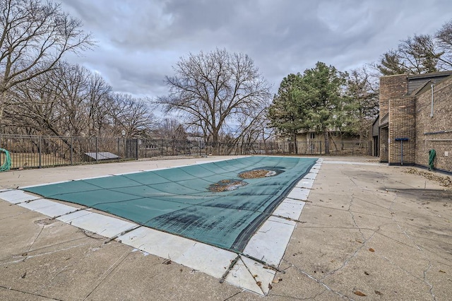 view of swimming pool featuring a fenced in pool, a patio area, and fence