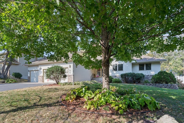 view of front of property with a garage and a front lawn