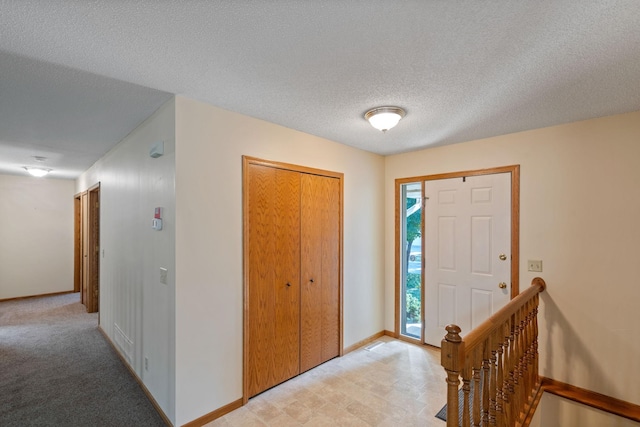 foyer entrance with a textured ceiling