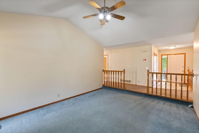 carpeted empty room with ceiling fan and vaulted ceiling