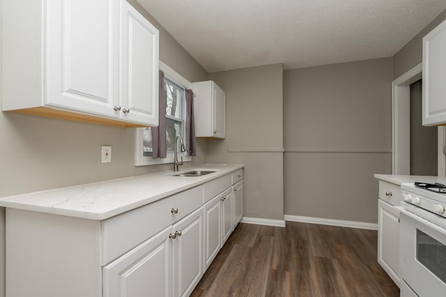 kitchen with white cabinets, sink, dark wood-type flooring, and white stove