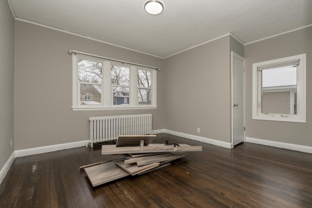 interior space with radiator, dark hardwood / wood-style flooring, and a textured ceiling