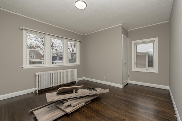 unfurnished room featuring ornamental molding, a textured ceiling, radiator, and dark wood-type flooring