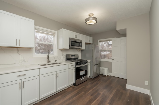 kitchen featuring white cabinetry, a healthy amount of sunlight, sink, and stainless steel appliances