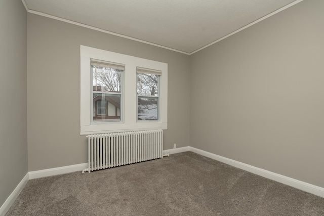 carpeted spare room featuring radiator heating unit and ornamental molding