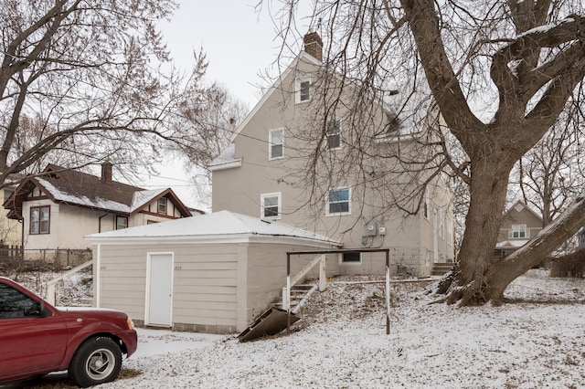 view of snow covered rear of property