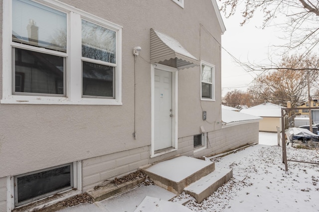 view of snow covered property entrance