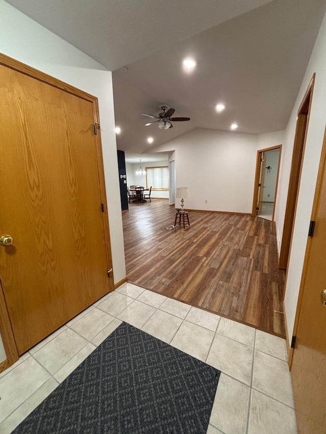 entryway with ceiling fan, light hardwood / wood-style flooring, and lofted ceiling