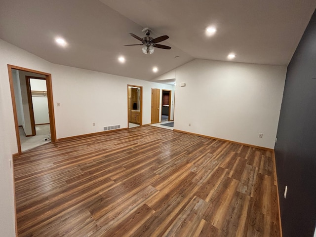 unfurnished living room with dark hardwood / wood-style flooring, vaulted ceiling, and ceiling fan