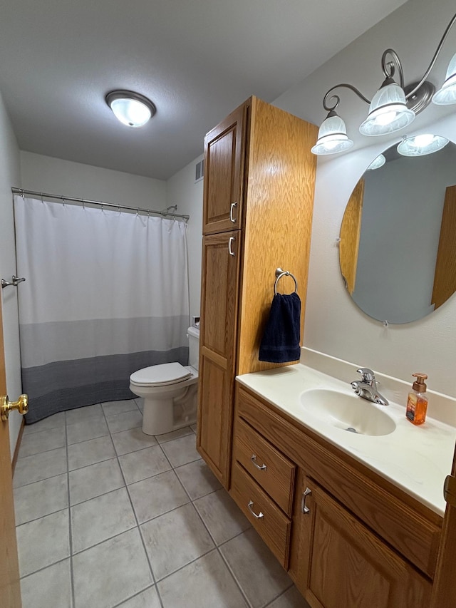 bathroom featuring tile patterned floors, vanity, and toilet